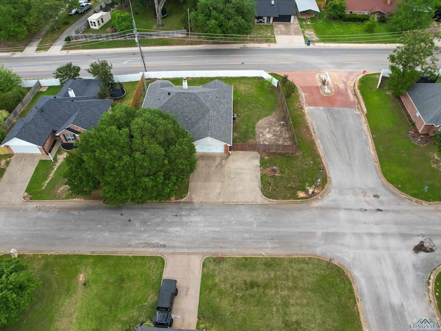 aerial view of property and surrounding area featuring nearby suburban area
