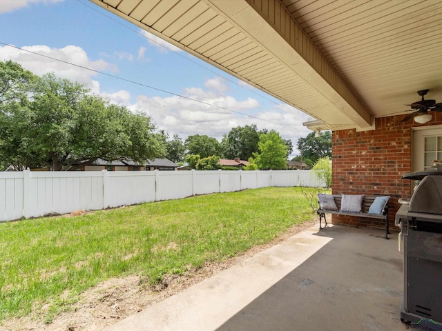 view of yard featuring a ceiling fan and a patio area
