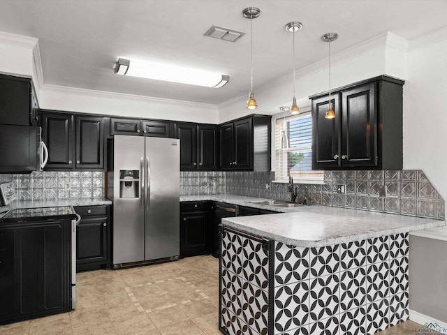 kitchen with stainless steel appliances, dark cabinetry, a peninsula, a sink, and ornamental molding