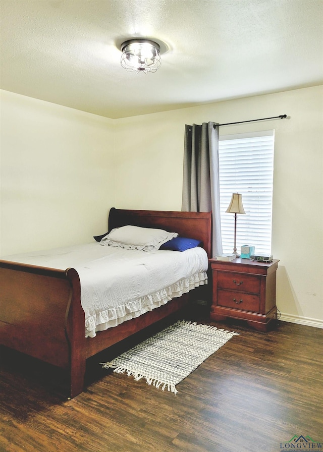 bedroom featuring dark wood-type flooring