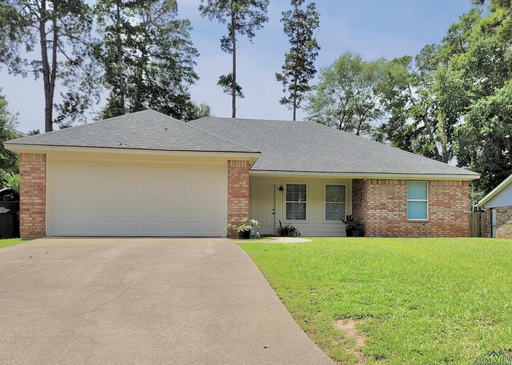 single story home with a garage and a front yard