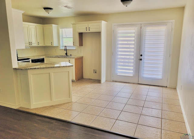 kitchen featuring french doors, sink, decorative backsplash, light tile patterned floors, and light stone counters