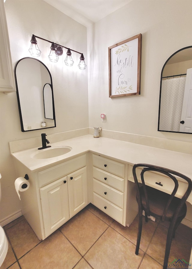 bathroom with tile patterned floors, vanity, and toilet