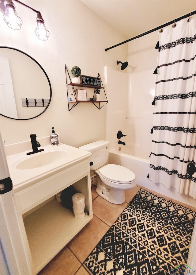 full bathroom featuring toilet, shower / bath combination with curtain, tile patterned floors, and sink