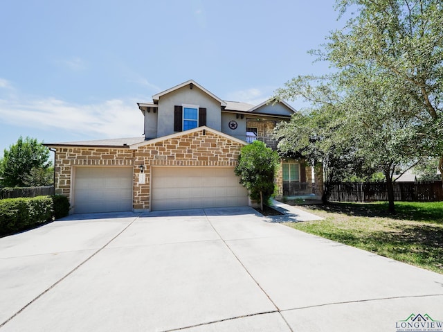 1126 Ruddy Duck, New Braunfels, TX 78130 - view of front of property featuring a garage, concrete driveway, stone siding, and stucco siding
