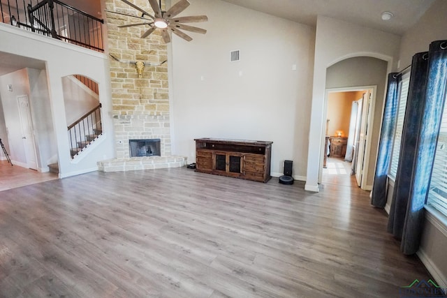 1126 Ruddy Duck, New Braunfels, TX 78130 - unfurnished living room featuring a ceiling fan, stairway, high vaulted ceiling, wood finished floors, and baseboards