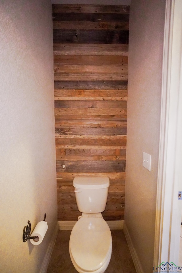 1126 Ruddy Duck, New Braunfels, TX 78130 - bathroom with baseboards, wood walls, and toilet