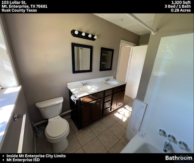 full bathroom featuring vanity, toilet, tile patterned floors, and bathing tub / shower combination