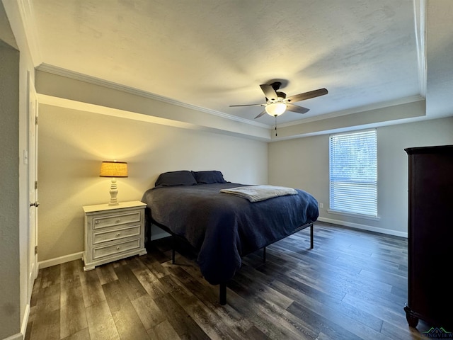 bedroom featuring ceiling fan, dark hardwood / wood-style flooring, ornamental molding, and a raised ceiling