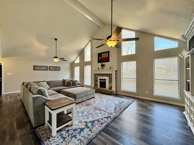 living room with dark hardwood / wood-style floors, a fireplace, beam ceiling, a textured ceiling, and high vaulted ceiling