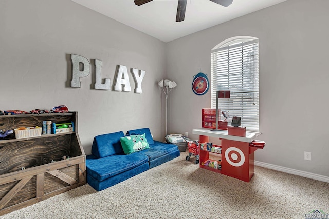 recreation room with carpet floors, baseboards, and a ceiling fan