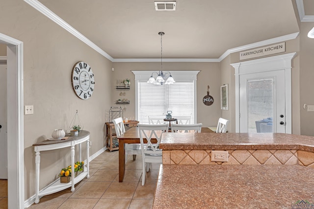 kitchen with ornamental molding, light tile patterned flooring, visible vents, and an inviting chandelier