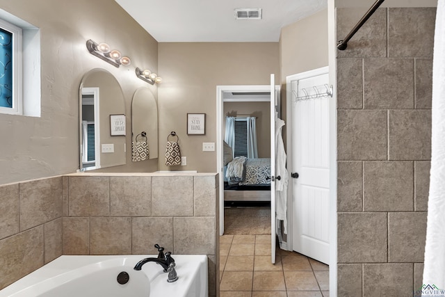 ensuite bathroom with a garden tub, visible vents, ensuite bathroom, and tile patterned floors