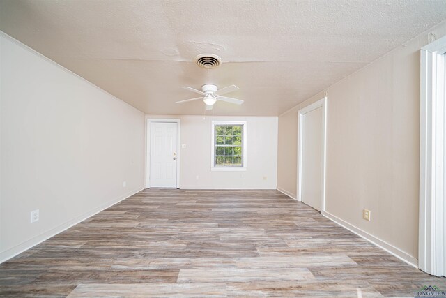 206 Empire St, Gladewater, TX 75647 - spare room with ceiling fan, wood finished floors, and a textured ceiling