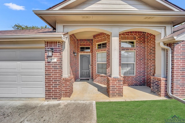 view of exterior entry featuring a garage