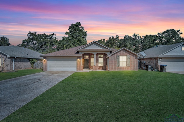 ranch-style home with a lawn and a garage