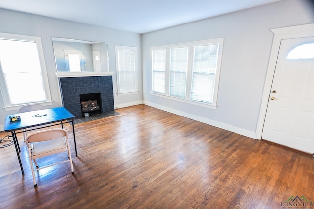 entrance foyer with hardwood / wood-style floors and a fireplace