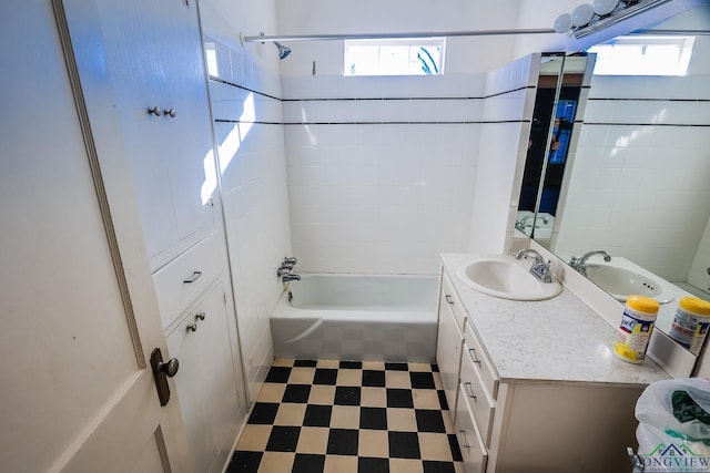 bathroom featuring vanity, tiled shower / bath combo, and a wealth of natural light