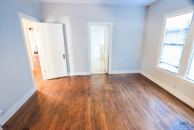 unfurnished room featuring dark hardwood / wood-style floors