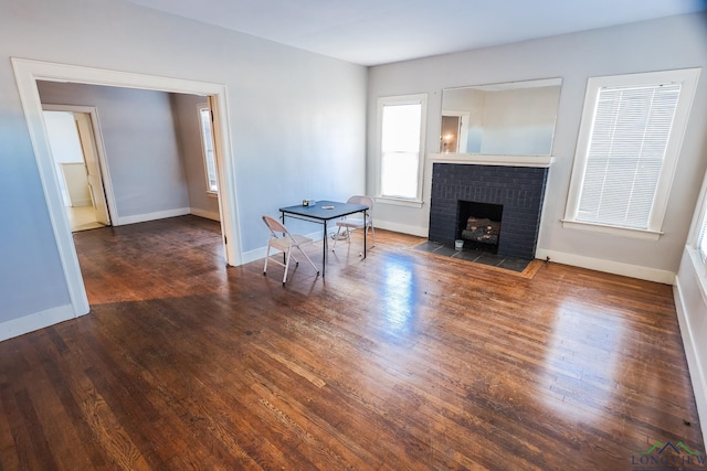 living room featuring a fireplace and dark hardwood / wood-style flooring