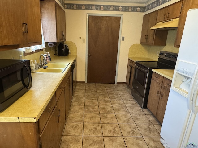 kitchen featuring black appliances, under cabinet range hood, light countertops, and a sink