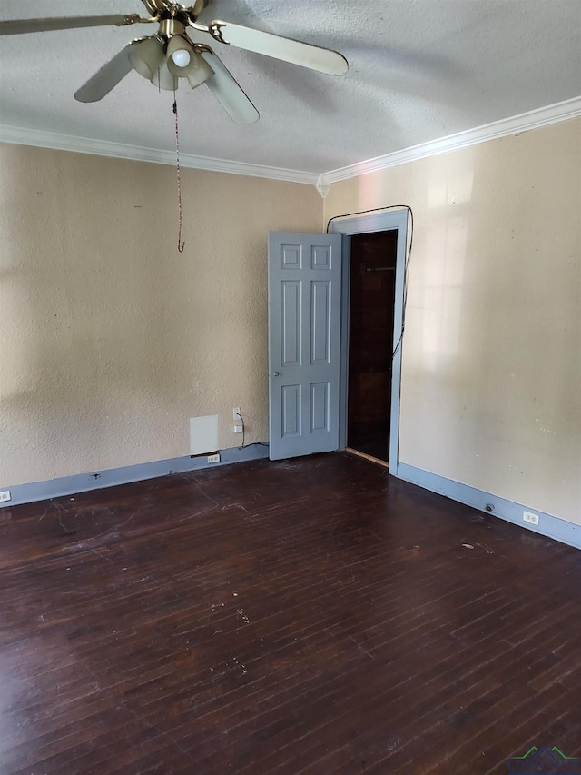 spare room with a textured ceiling, dark hardwood / wood-style floors, and ornamental molding