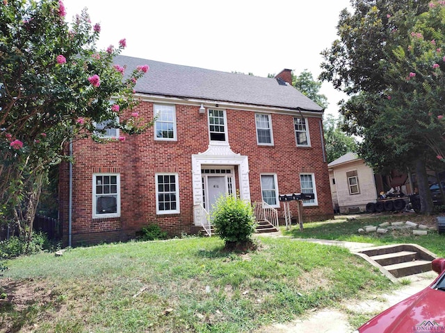 colonial home with a front yard