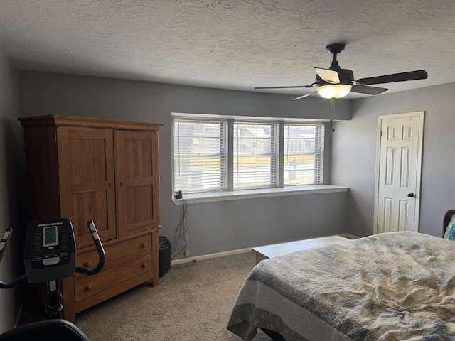 bedroom with a textured ceiling, ceiling fan, carpet, and baseboards