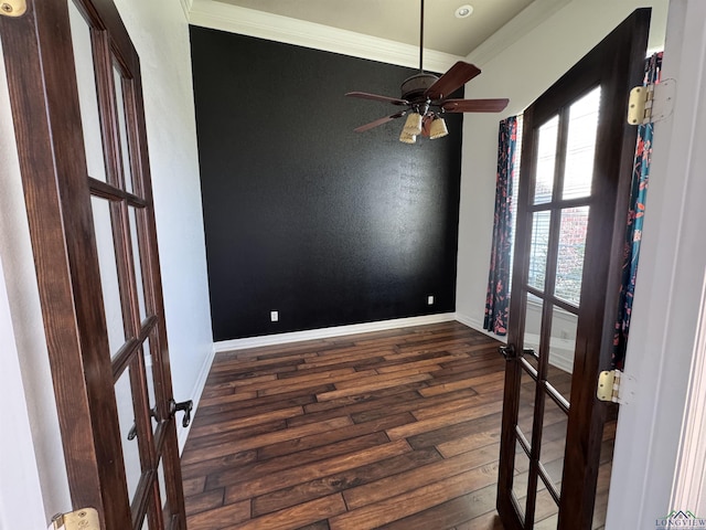 empty room with french doors, dark wood-type flooring, ceiling fan, and ornamental molding