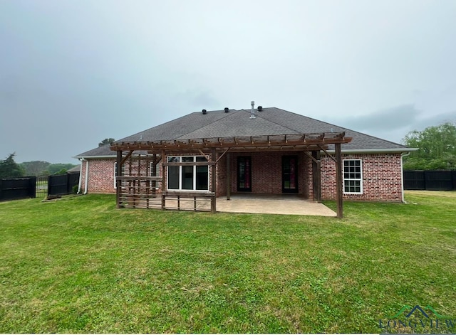 rear view of house featuring a patio area and a lawn