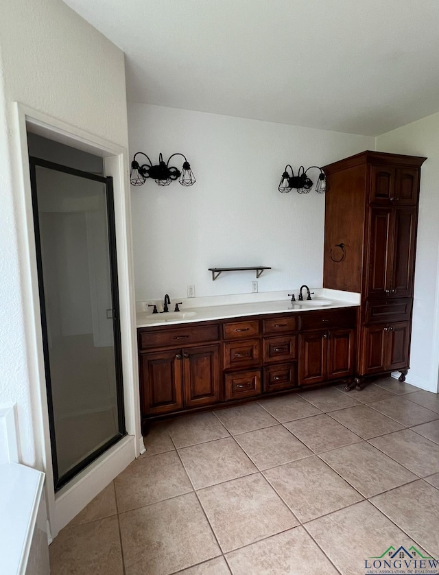 bathroom featuring tile patterned floors, vanity, and a shower with door