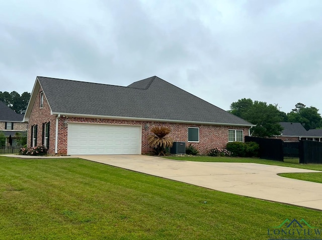 view of side of home featuring a yard and central AC