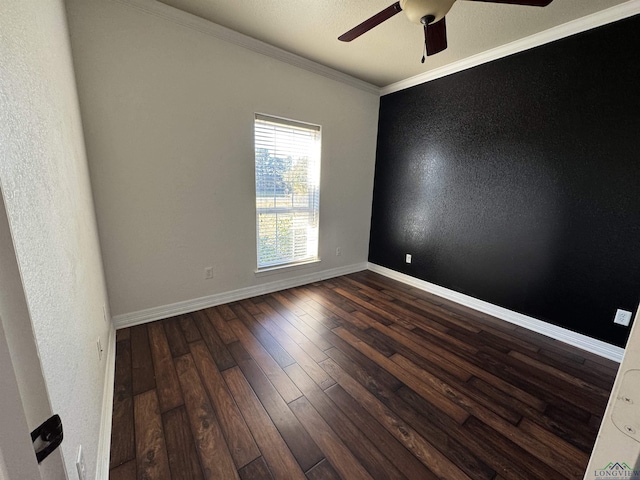 empty room with crown molding, ceiling fan, and dark wood-type flooring