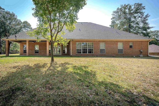 back of house featuring a lawn