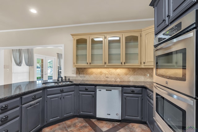 kitchen with cream cabinetry, sink, appliances with stainless steel finishes, and french doors