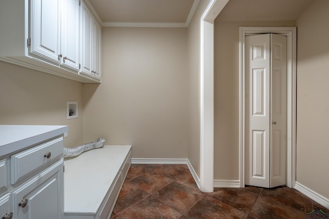 washroom with crown molding, hookup for a washing machine, and cabinets