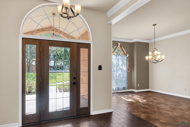 foyer with an inviting chandelier and crown molding