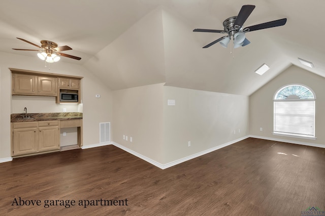 interior space featuring dark hardwood / wood-style flooring, ceiling fan, and lofted ceiling