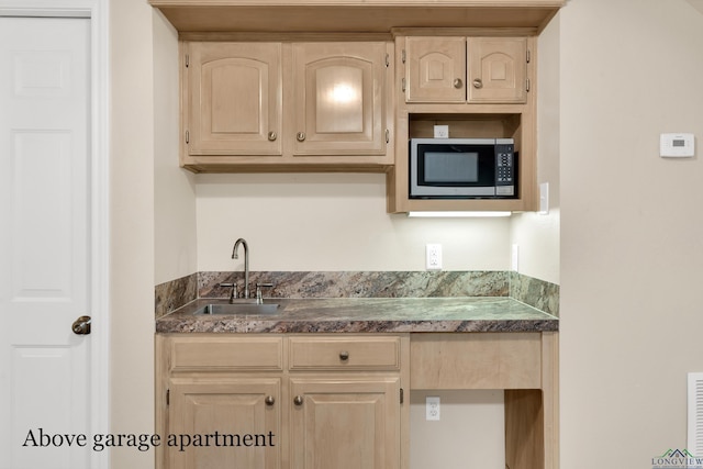 kitchen with light brown cabinets and sink