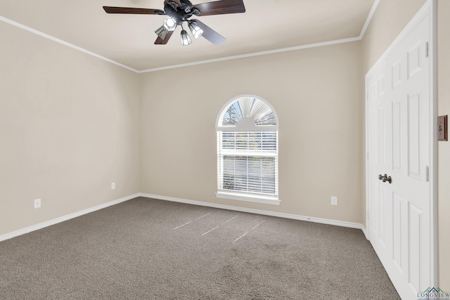 carpeted spare room with ceiling fan and crown molding