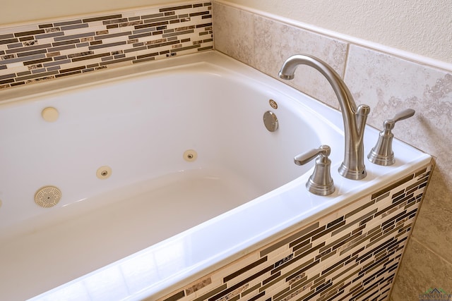 room details featuring a relaxing tiled tub and sink