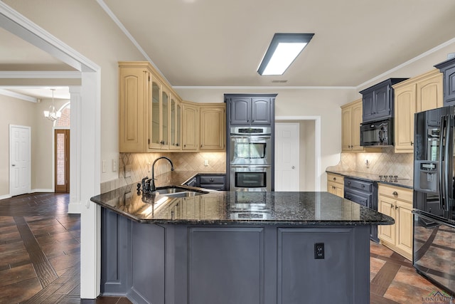 kitchen with kitchen peninsula, backsplash, sink, black appliances, and a chandelier