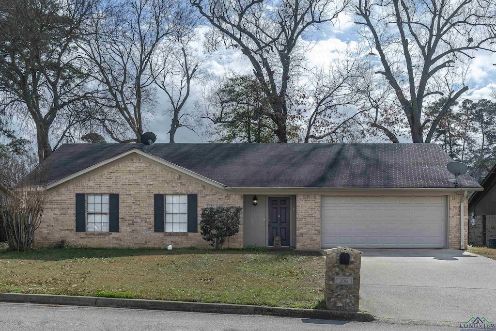 ranch-style house featuring a front lawn, brick siding, driveway, and an attached garage