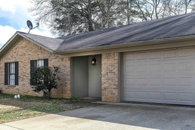 view of front of property with a garage, brick siding, and driveway