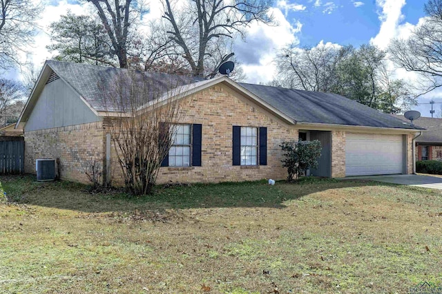 view of front of house with a garage, a front yard, and brick siding