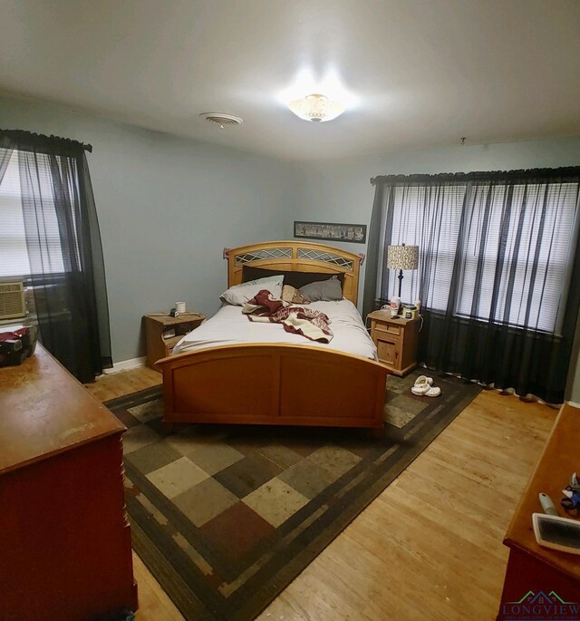 bedroom with hardwood / wood-style floors