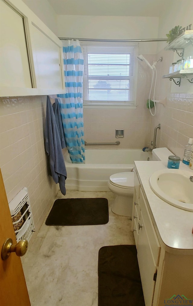 full bathroom with vanity, toilet, tile walls, and shower / tub combo