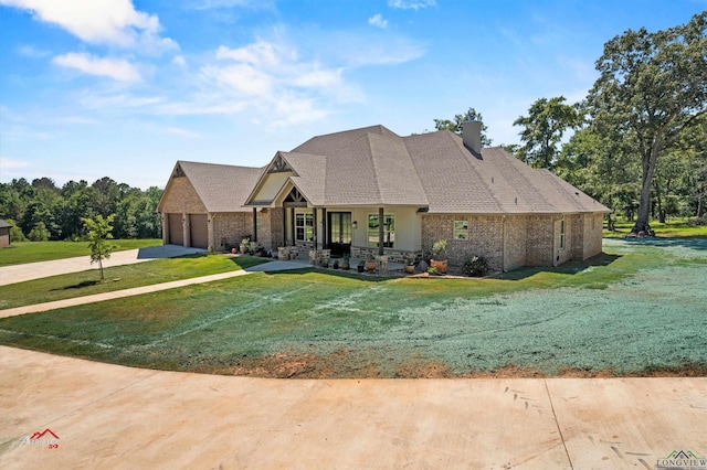 view of front of house with a garage and a front lawn