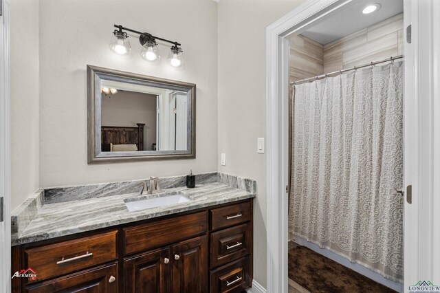 bathroom featuring curtained shower and vanity