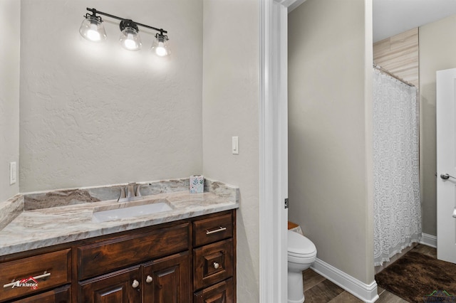 bathroom featuring vanity, toilet, and wood-type flooring